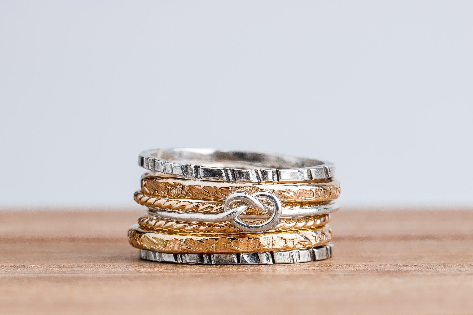 Love Knot Mixed Metal Stacking Ring Set Of 7 | Sterling Silver and 14K Gold Fill Stack Stackable Knotted Tied Hammered Rings | Tie The Knot