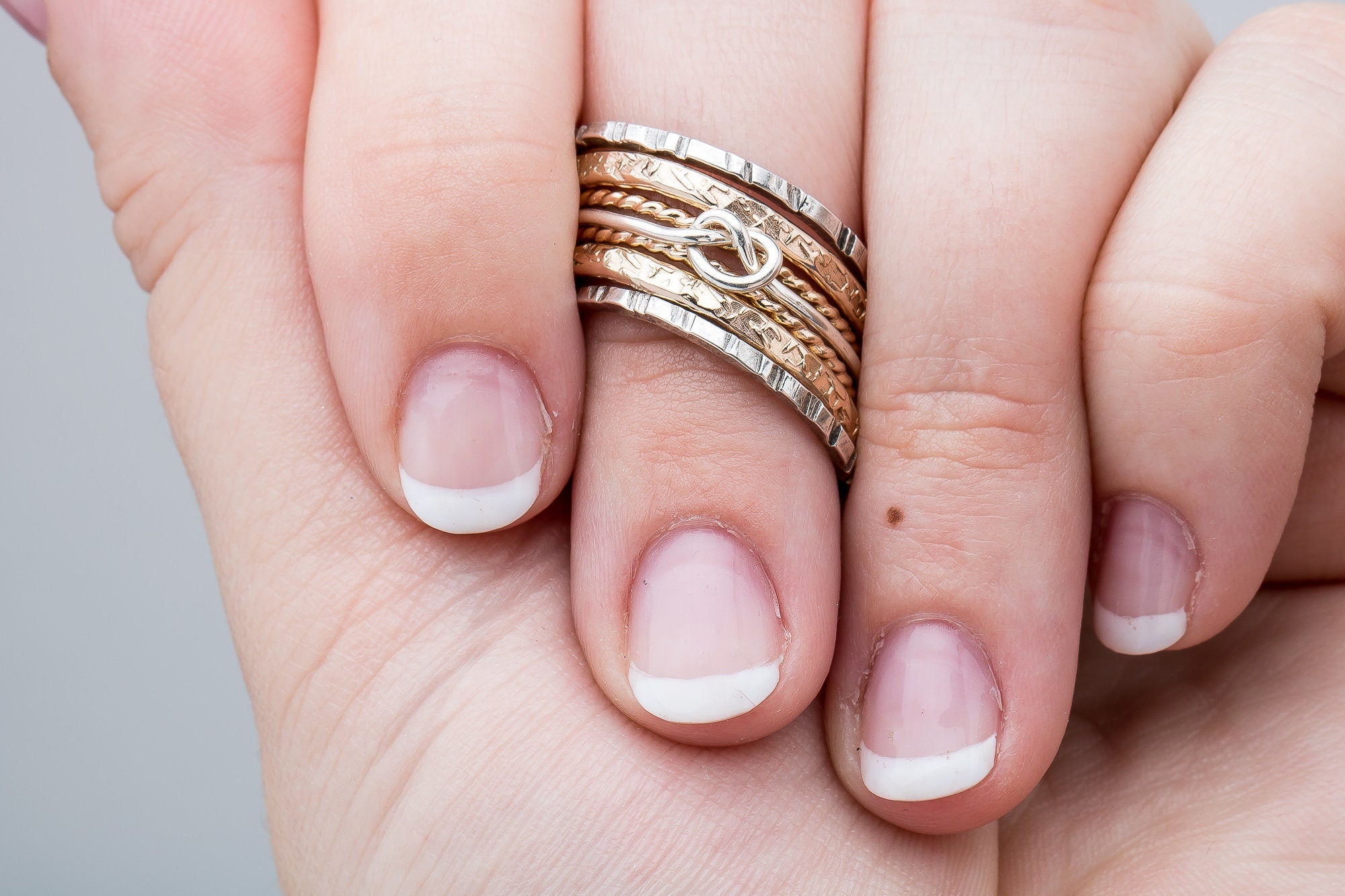 Love Knot Mixed Metal Stacking Ring Set Of 7 | Sterling Silver and 14K Gold Fill Stack Stackable Knotted Tied Hammered Rings | Tie The Knot